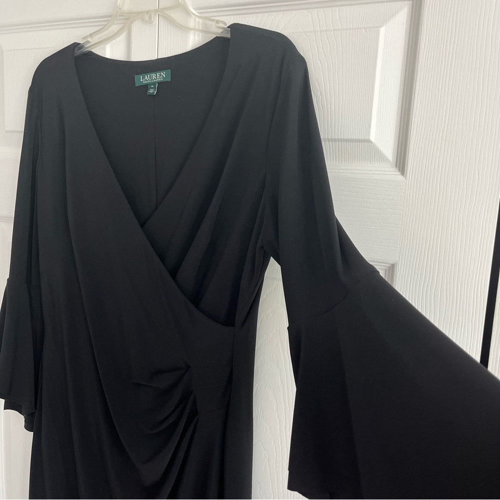 Elegant black Lauren dress with flutter sleeve and mock wrap.